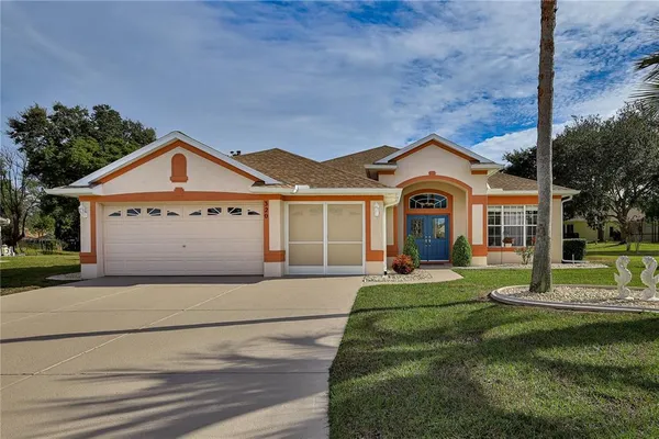 a front view of a house with a yard and garage