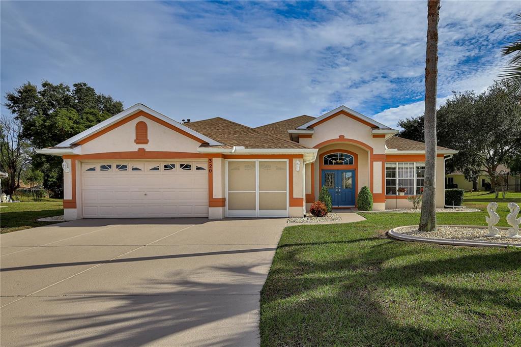 a front view of a house with a yard and garage