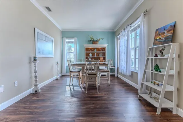 a workspace with furniture wooden floor and a chandelier