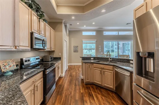 a bedroom with a bed and a lamp on dresser