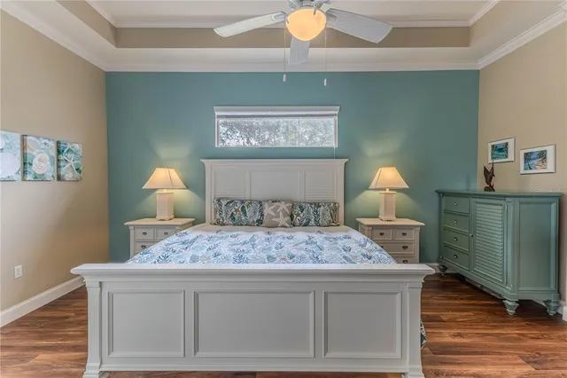 a bedroom with a bed and a painting on the wall