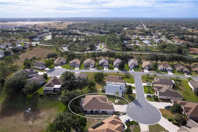 a view of backyard with deck and outdoor seating