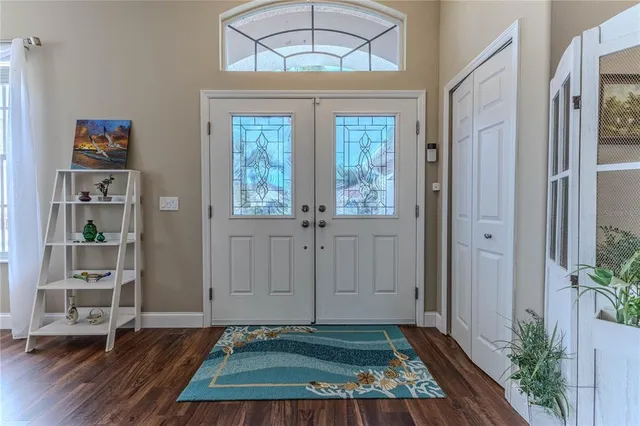 a view of a dining room with furniture a chandelier and wooden floor
