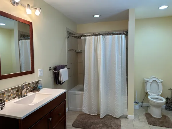 a bathroom with a sink toilet and shower