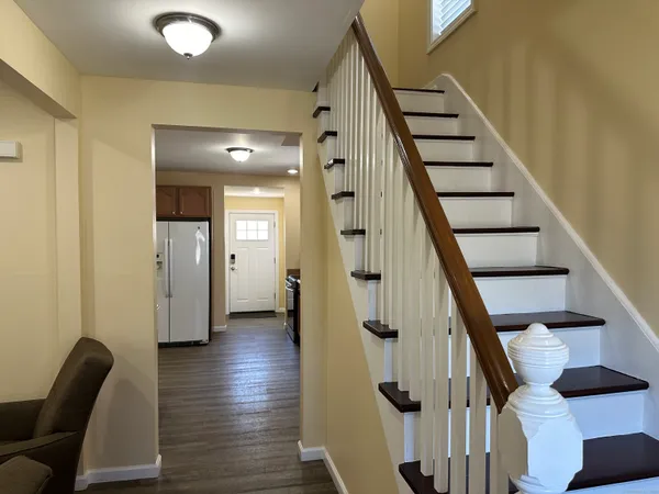 a view of entryway with wooden floor and stairs