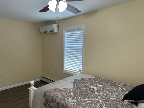 a bedroom with a bed and a chandelier