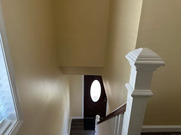 a view of staircase with railing and a painting on the wall