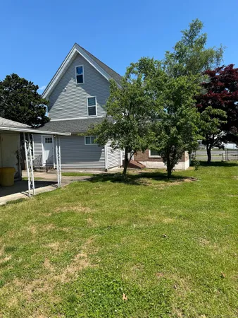 a view of house with garden space and trees