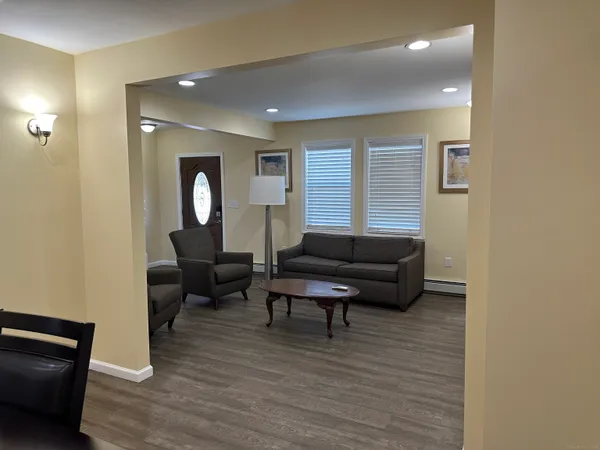a living room with furniture and a wooden floor