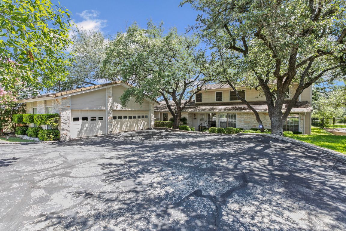 415 Dasher Drive Lakeway, TX 78734 - Photo 1 of 38 a front view of a house with a yard