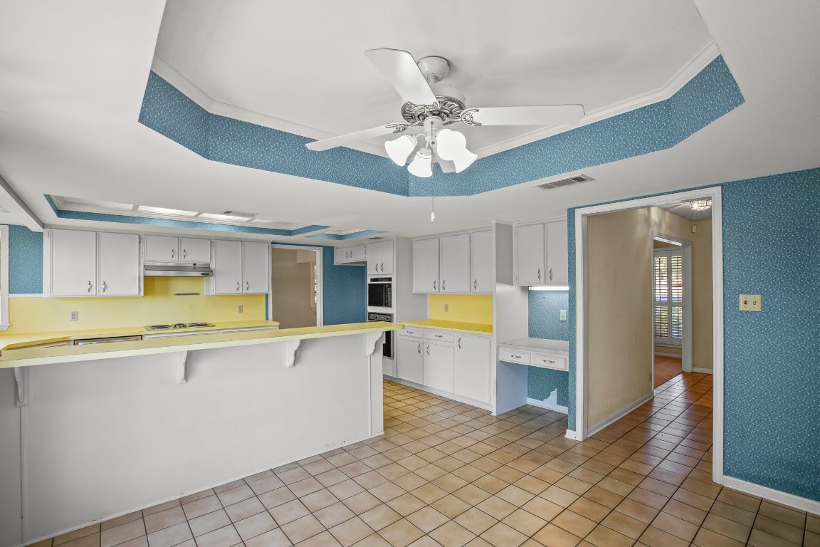415 Dasher Drive Lakeway, TX 78734 - Photo 16 of 38 a view of a kitchen with a sink and cabinets