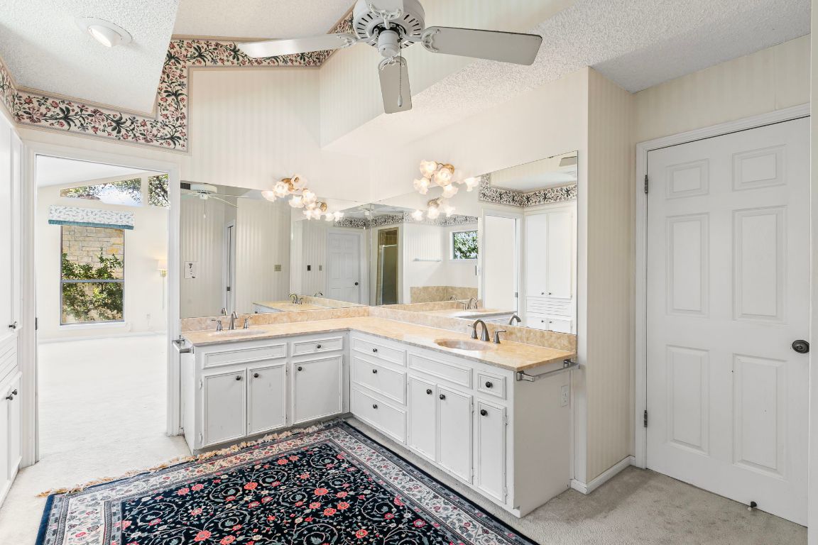 415 Dasher Drive Lakeway, TX 78734 - Photo 21 of 38 a room with a sink and a window