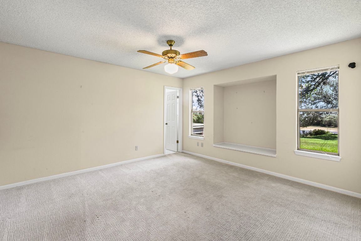415 Dasher Drive Lakeway, TX 78734 - Photo 23 of 38 wooden floor in an empty room with a window