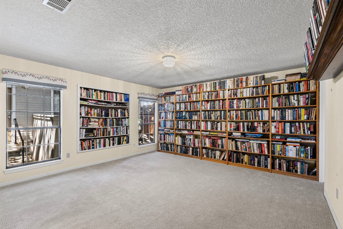 415 Dasher Drive Lakeway, TX 78734 - Photo 26 of 38 a view of an empty room with furniture and staircase