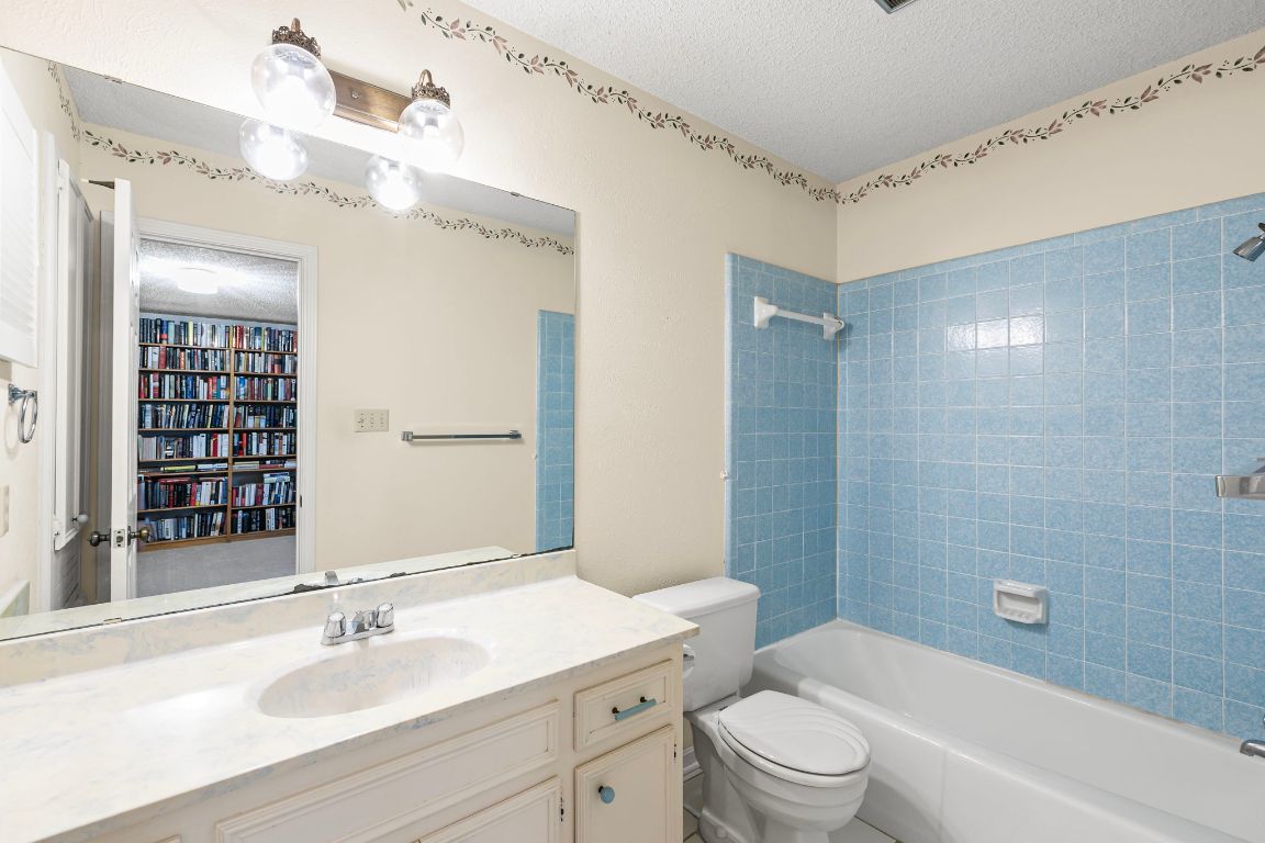 415 Dasher Drive Lakeway, TX 78734 - Photo 28 of 38 a bathroom with a sink a toilet and shower