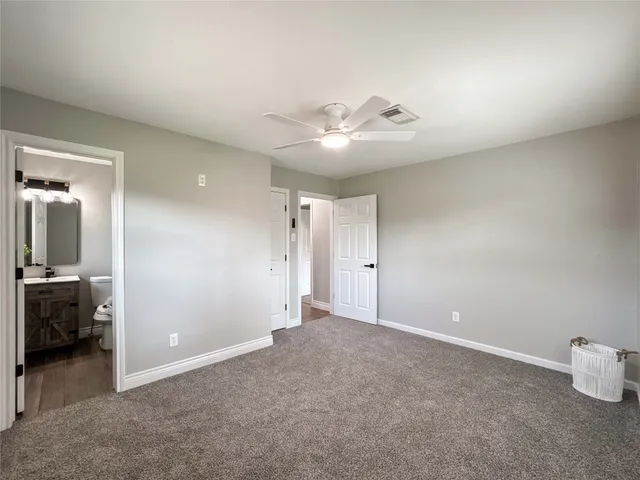 a view of an empty room and a bathroom
