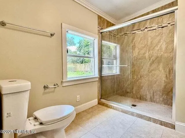 a bathroom with a shower and a toilet