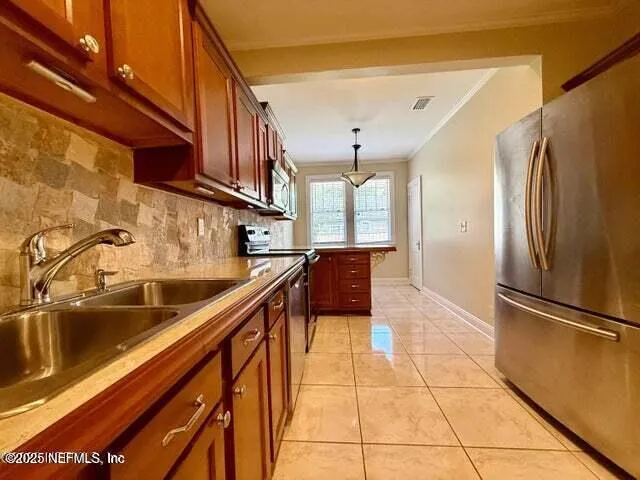 a kitchen with stainless steel appliances granite countertop a refrigerator and a sink