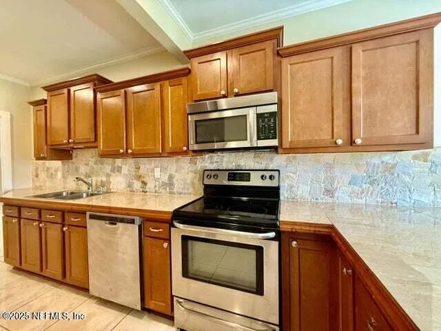 a kitchen with granite countertop wooden cabinets and a stove top oven