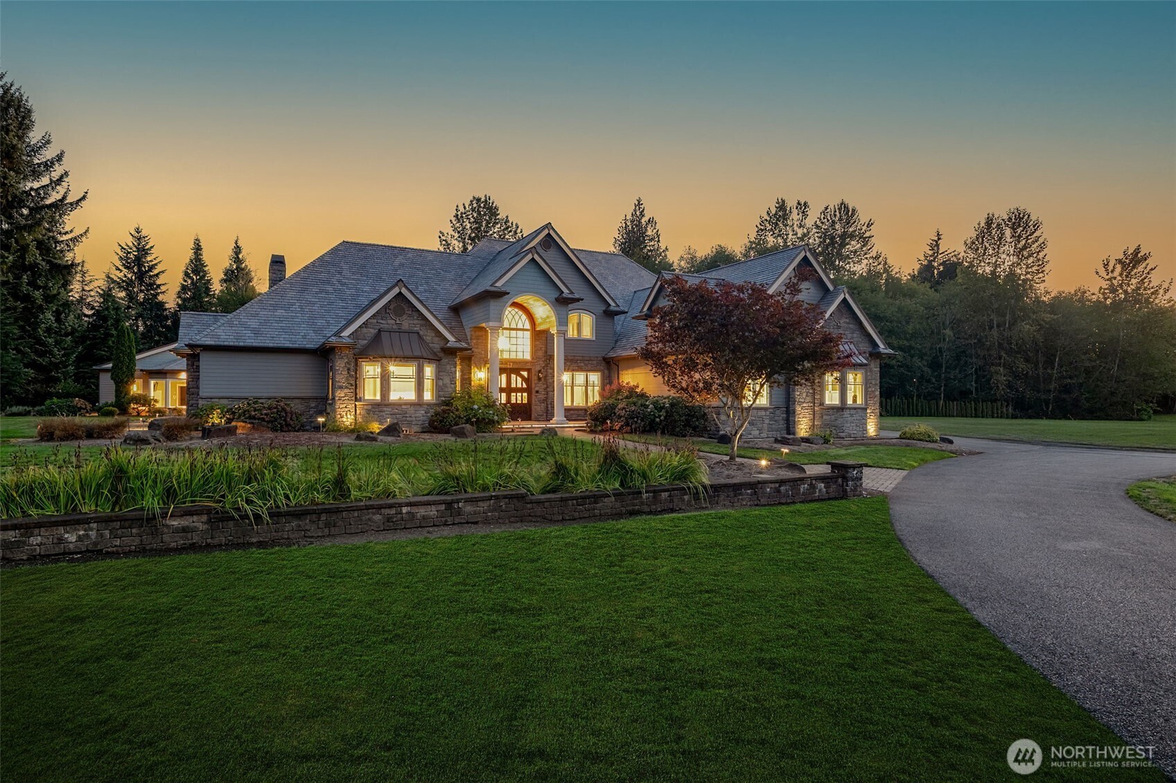 22029 238th Place Southeast Maple Valley, WA 98038 - Photo 1 of 40 a front view of a house with a garden