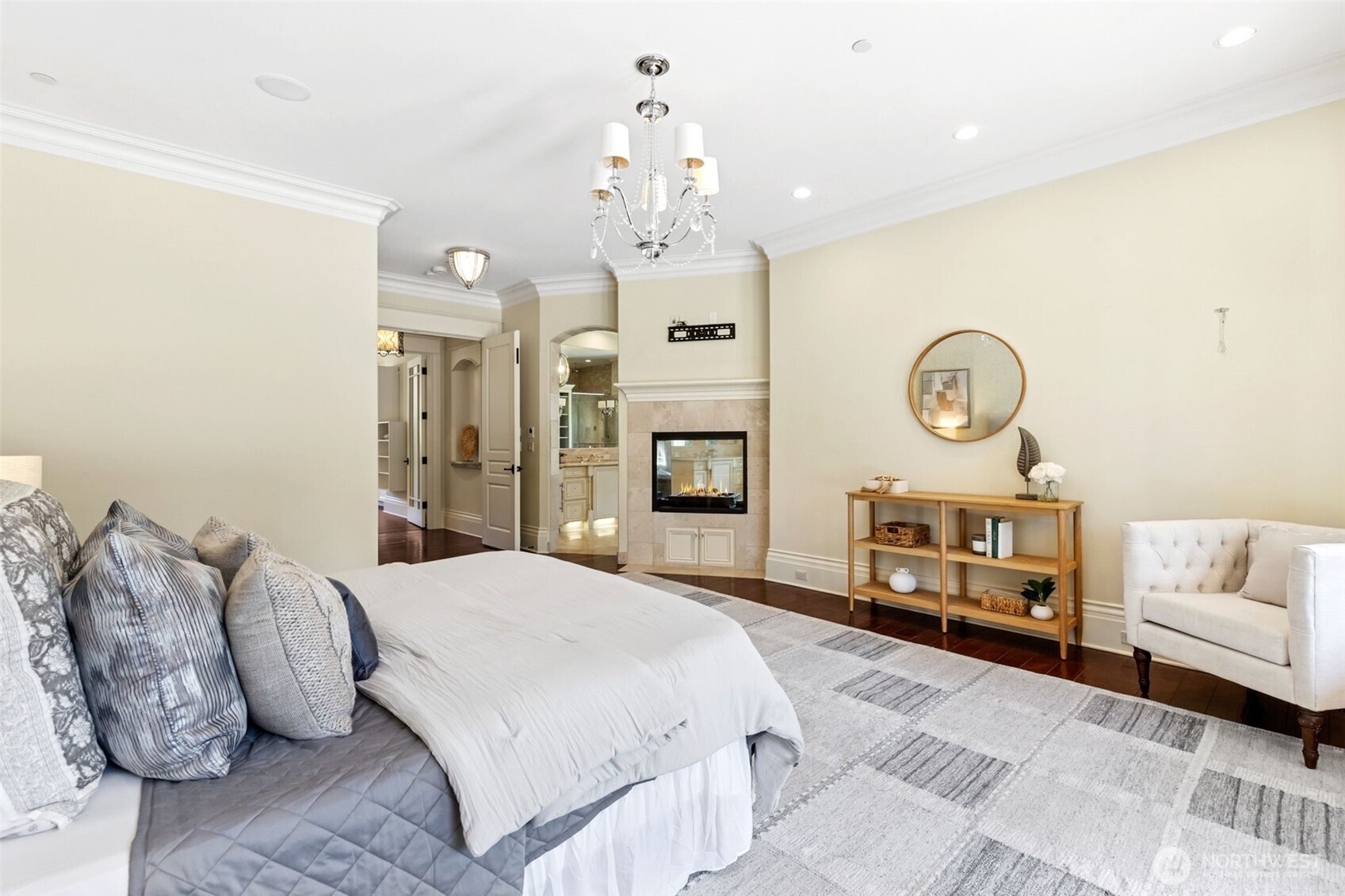 22029 238th Place Southeast Maple Valley, WA 98038 - Photo 20 of 40 a spacious bedroom with a bed a chandelier and dresser