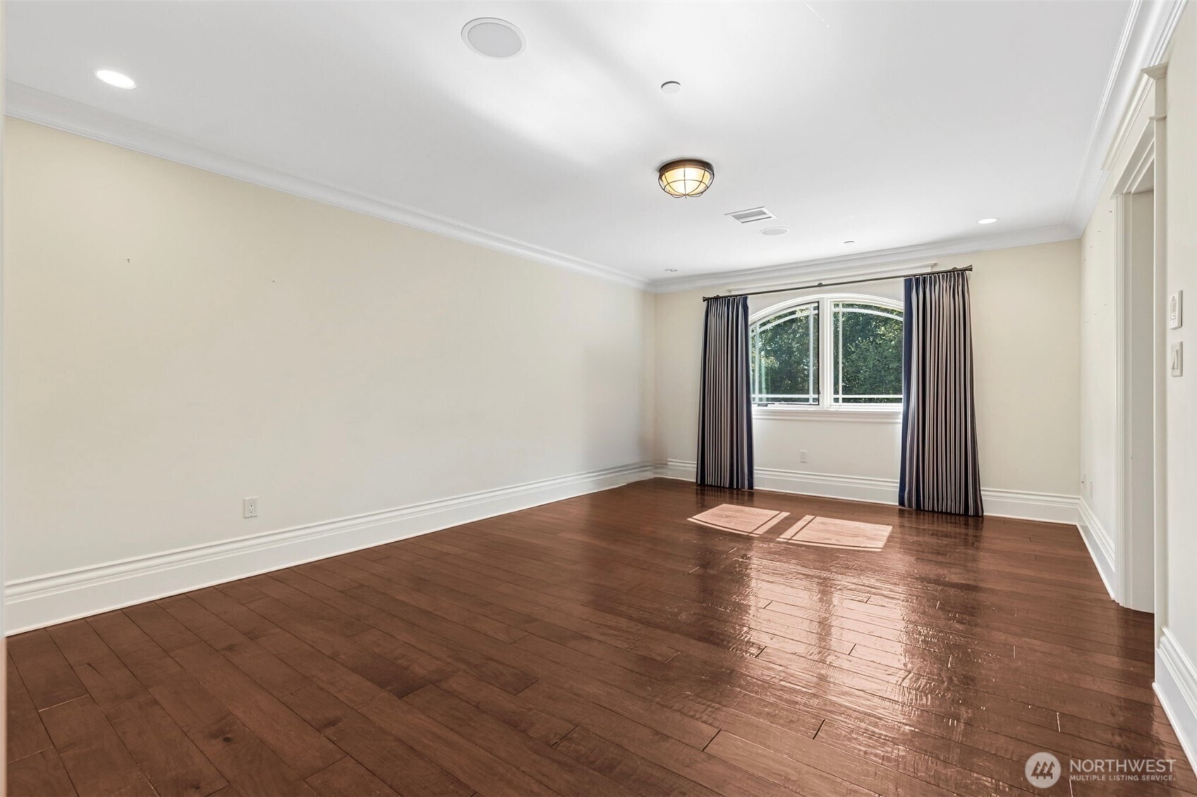 22029 238th Place Southeast Maple Valley, WA 98038 - Photo 27 of 40 an empty room with wooden floor and windows