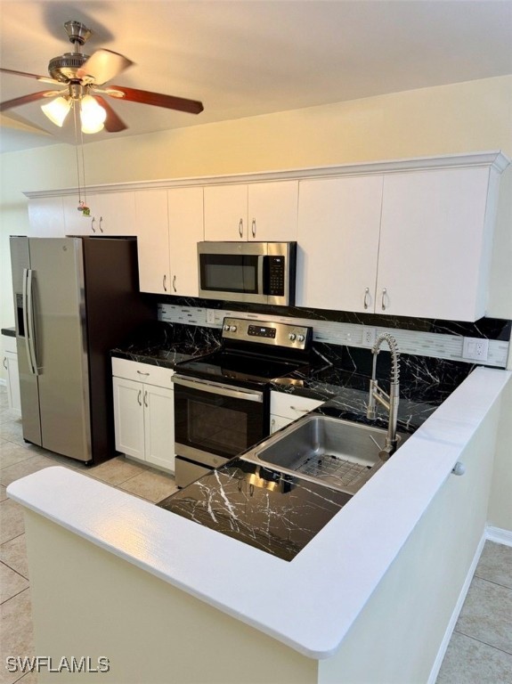 5013 Southwest 16th Place Cape Coral, FL 33914 - Photo 18 of 50 a kitchen with stainless steel appliances a microwave a sink and cabinets