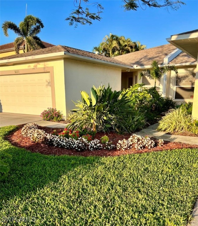 5013 Southwest 16th Place Cape Coral, FL 33914 - Photo 47 of 50 a view of a house with a yard and garden
