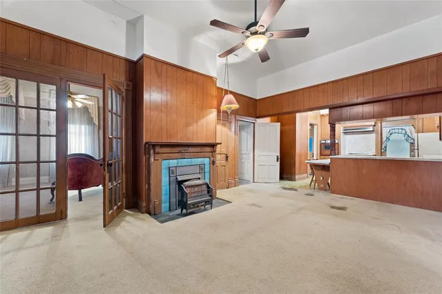 a view of an empty room with a fireplace and a window