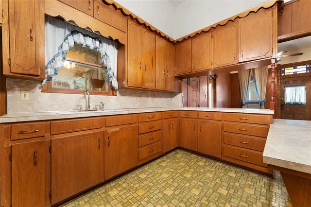 a kitchen with sink and cabinets