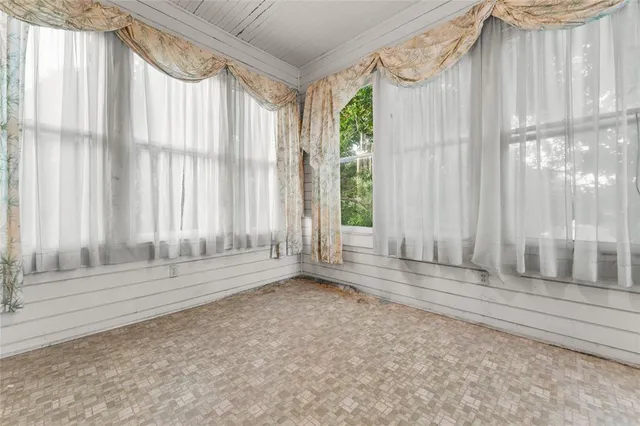 a view of wooden floor and windows in a room