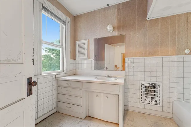 a bathroom with a sink a vanity and a mirror