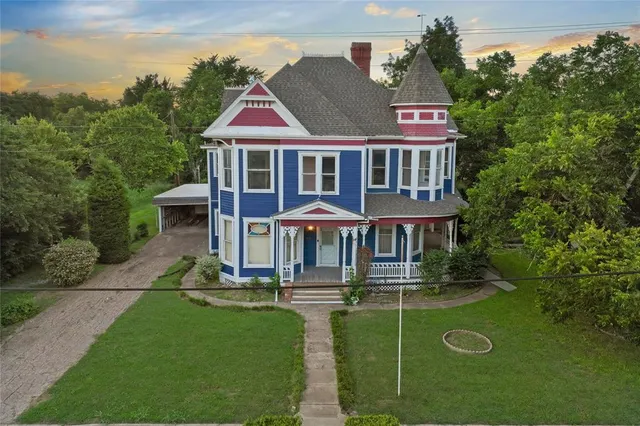 a front view of a house with a yard table and chairs