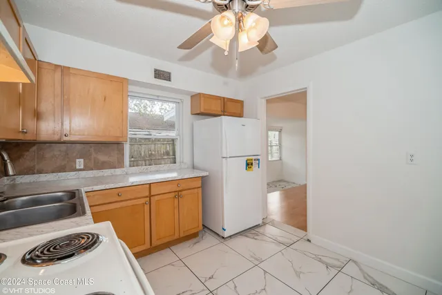 a kitchen with stainless steel appliances a stove a sink and a refrigerator