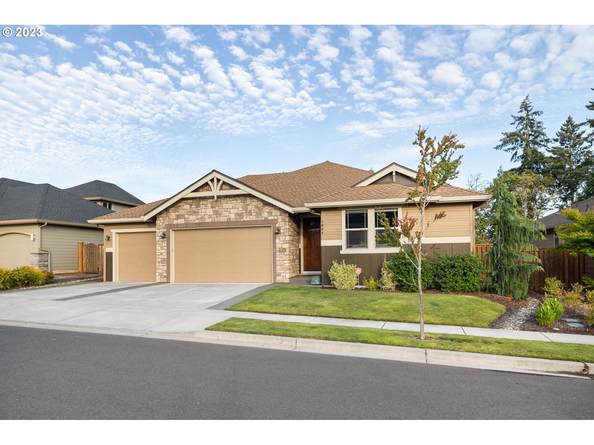 a front view of a house with a garden and yard