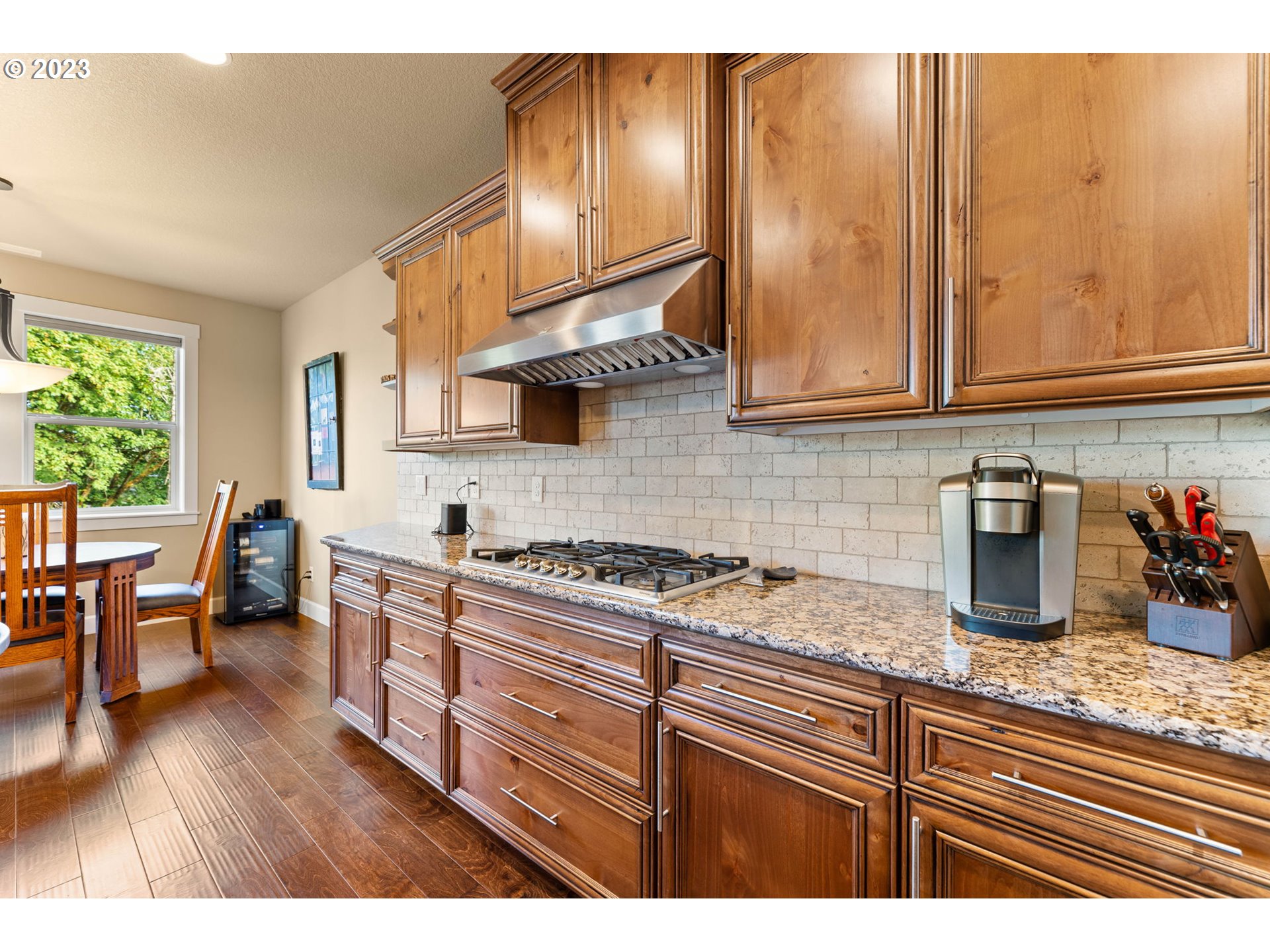 1845 South Harrier Road Ridgefield, WA 98642 - Photo 13 of 28 a kitchen with granite countertop a stove a sink and dishwasher wooden cabinets with granite countertops