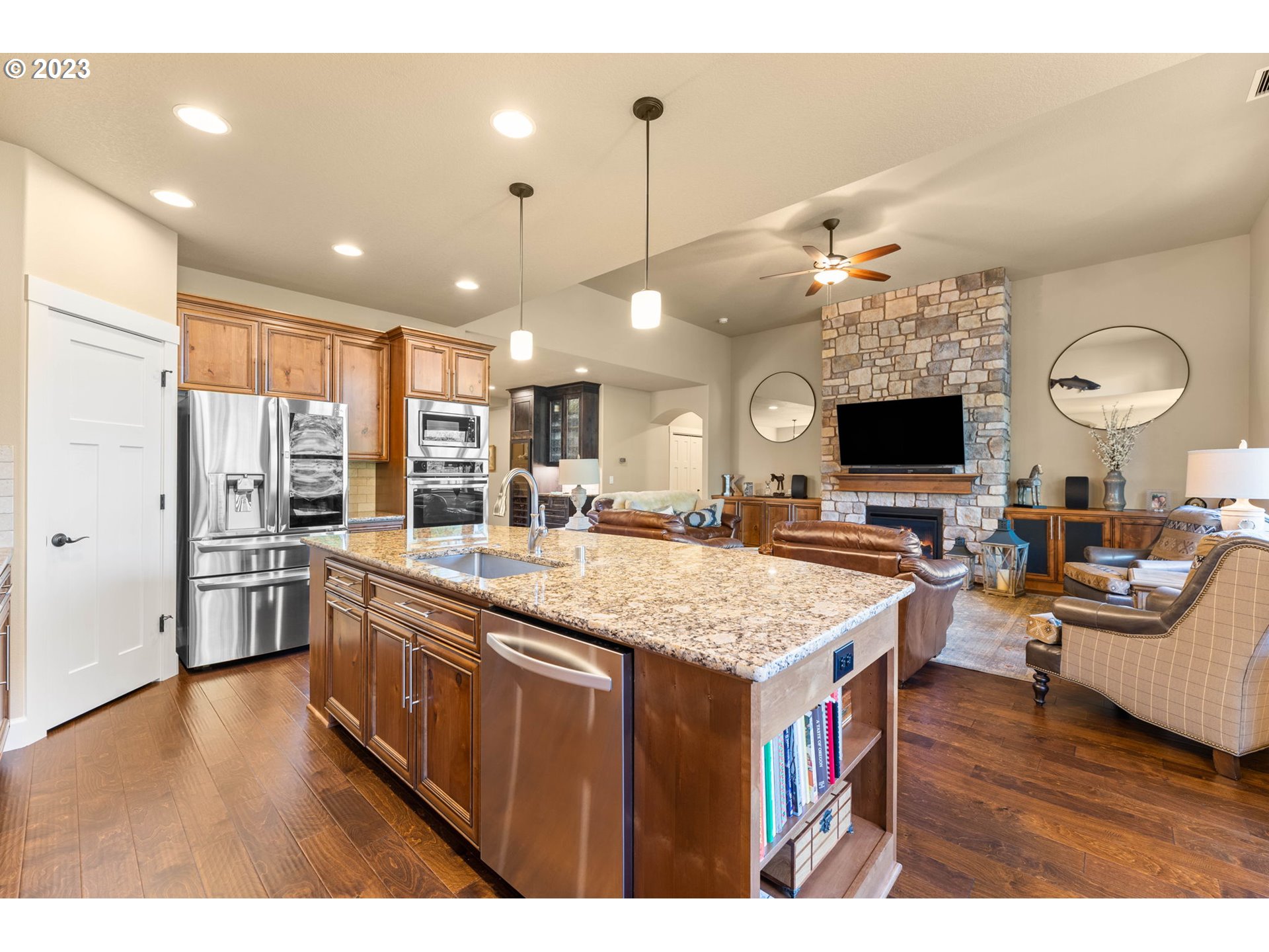 1845 South Harrier Road Ridgefield, WA 98642 - Photo 15 of 28 a large kitchen with kitchen island a flat screen tv center island and stainless steel appliances