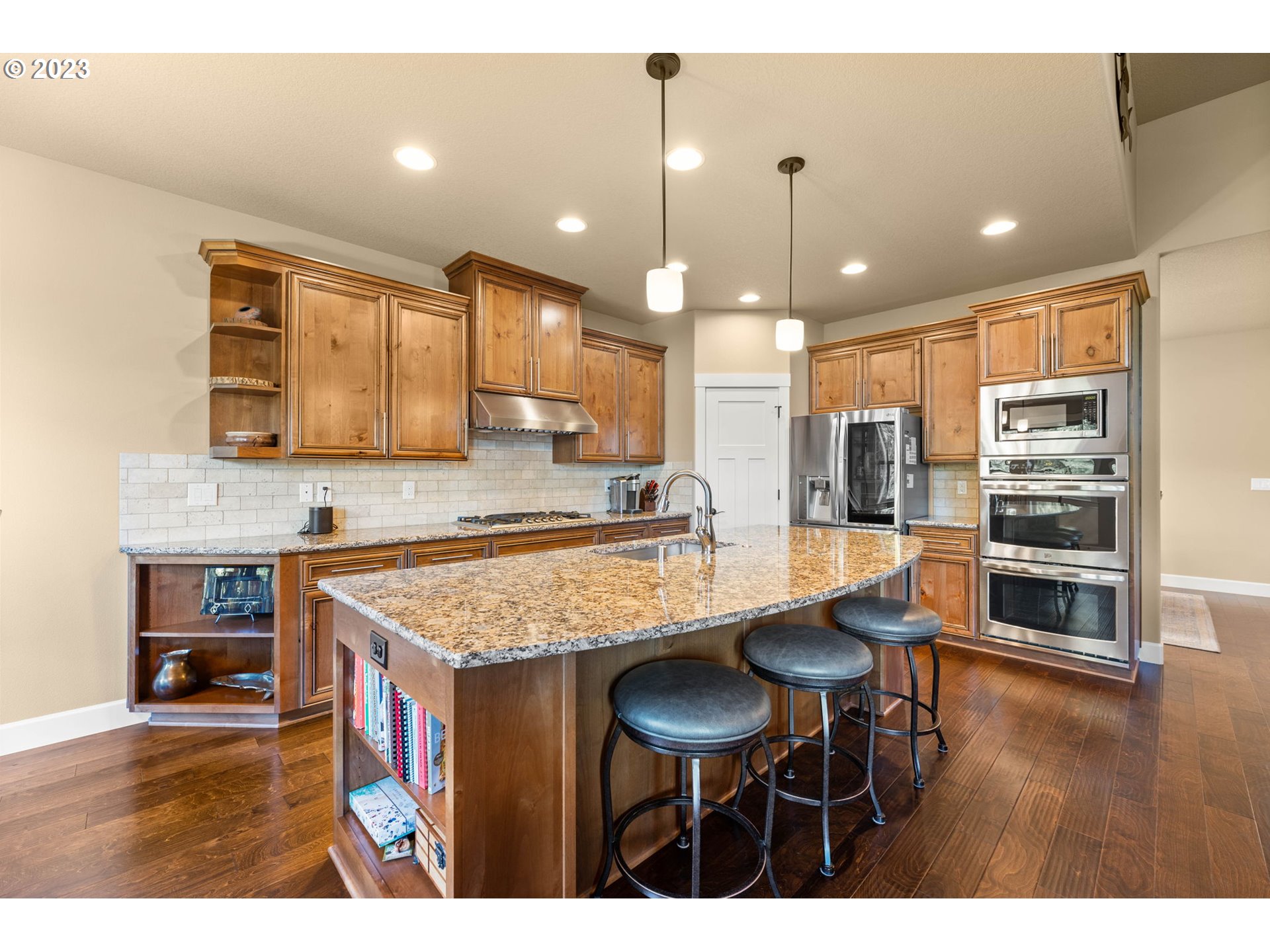 1845 South Harrier Road Ridgefield, WA 98642 - Photo 10 of 28 a kitchen with stainless steel appliances granite countertop a sink a stove a refrigerator and chairs