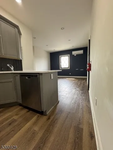 a view of a kitchen with wooden floor and electronic appliances