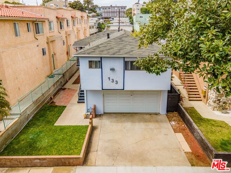 133 Whiting Street El Segundo, CA 90245 - Photo 2 of 14 a view of a house with a yard