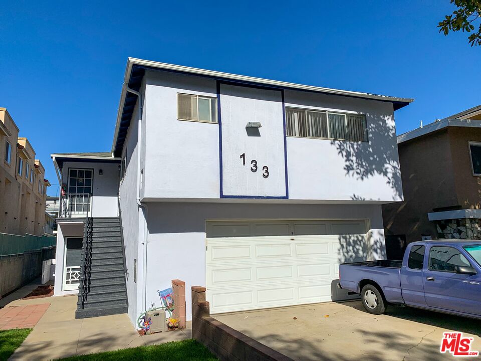 133 Whiting Street El Segundo, CA 90245 - Photo 8 of 14 a front view of a house with parking area