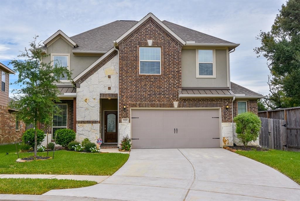 7002 Edwanna Lane Spring, TX 77389 - Photo 1 of 17 a front view of a house with a yard and garage