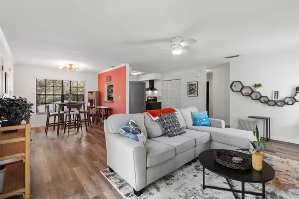 a living room with furniture and wooden floor