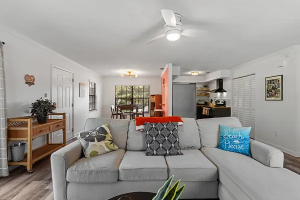 a living room with furniture and a chandelier