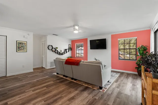 a living room with furniture and a flat screen tv