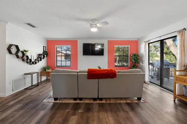 a living room with furniture window and wooden floor