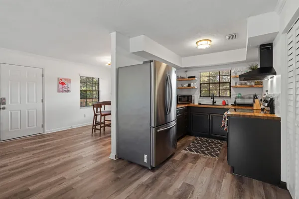 a kitchen with stainless steel appliances a refrigerator and a stove top oven