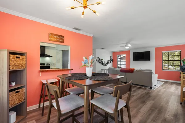 a view of a dining room with furniture and wooden floor
