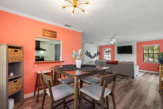 a view of a dining room with furniture and wooden floor