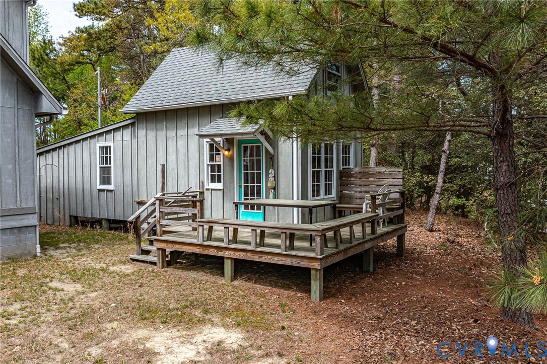 193 Deep Water Lane Reedville, VA 22539 - Photo 58 of 84 a view of a wooden deck with two chairs and a table